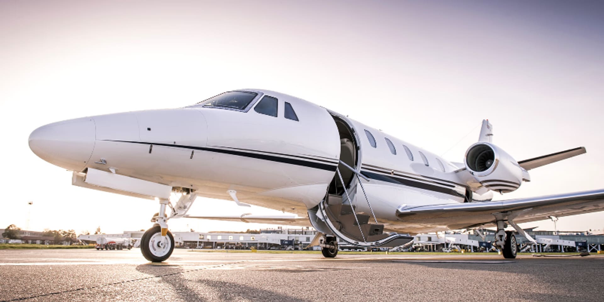 A white jet sitting on top of an airport runway.